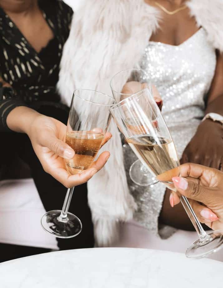 three women clinking champagne glasses together