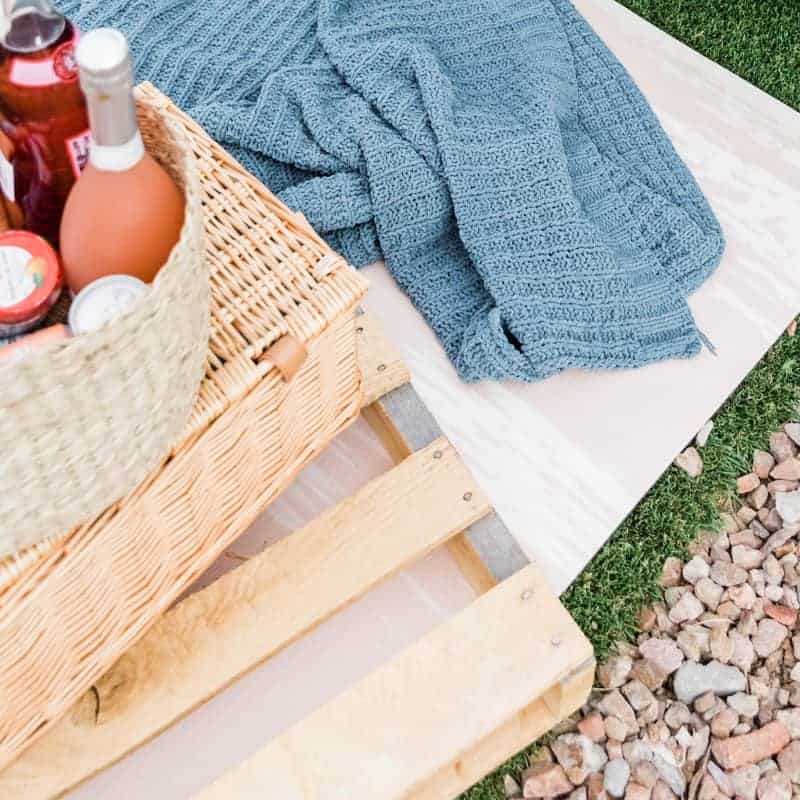picnic basket next to blanket