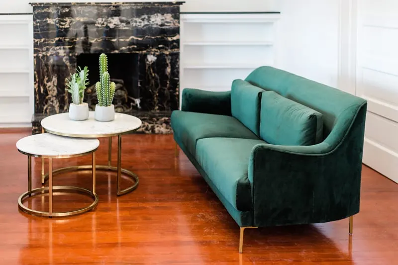 green couch with coffee table and fireplace