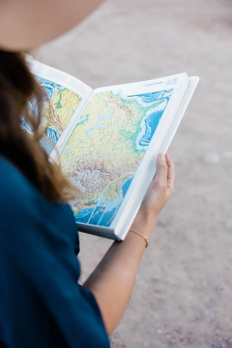 girl reading map of united states