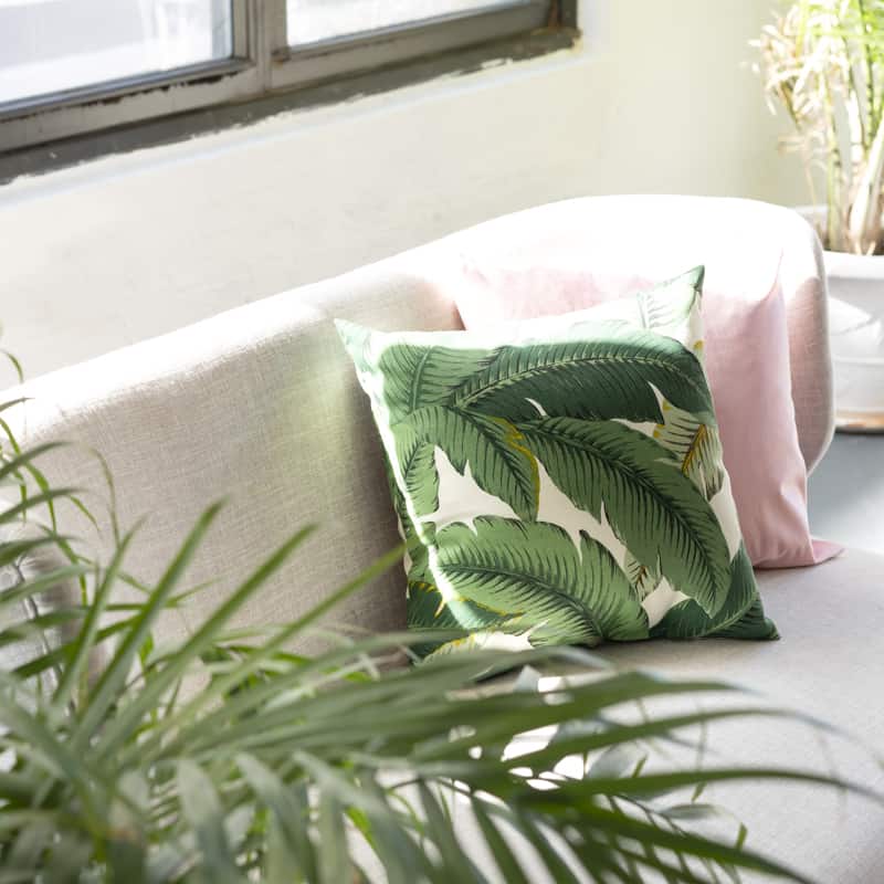 couch with green and pink pillows