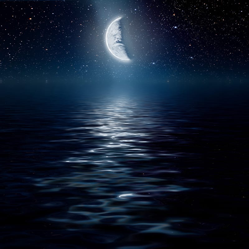 crescent moon over the ocean