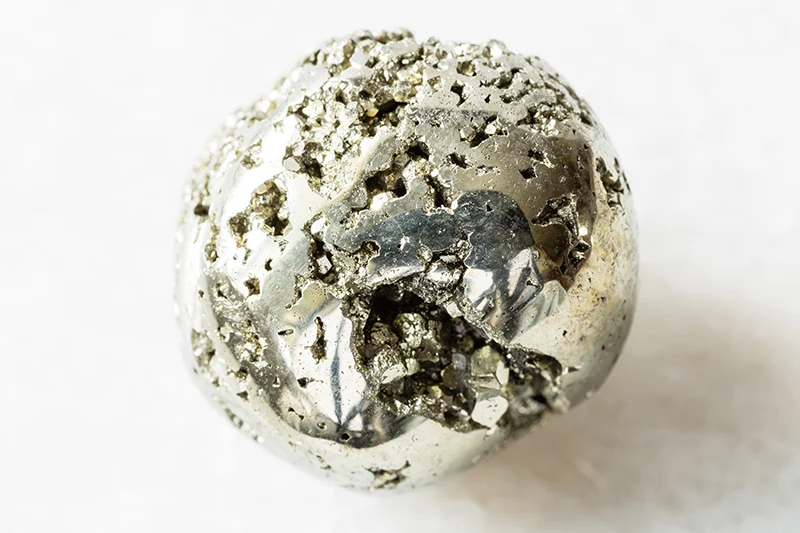 round pyrite nugget close up (how to use pyrite to attract money)