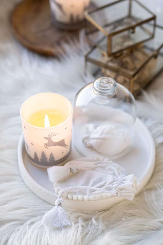 Cozy home decor with faux fur blanket, burning candles