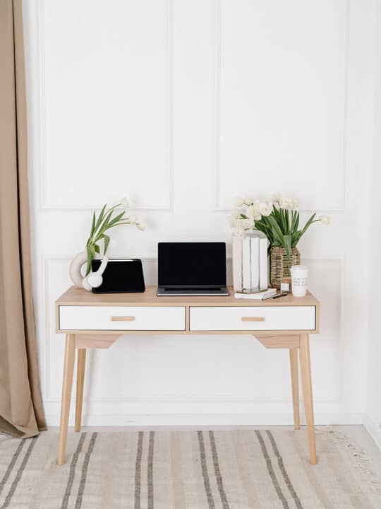 desk with laptop and decor items
