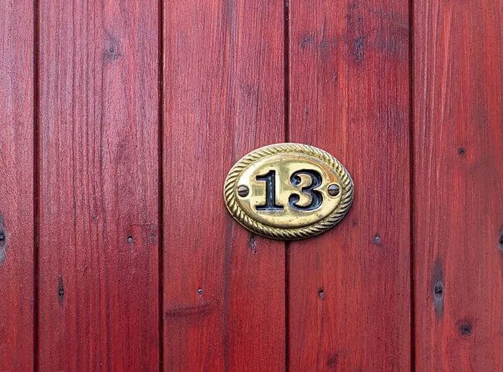 house number 13 in an oval plaque