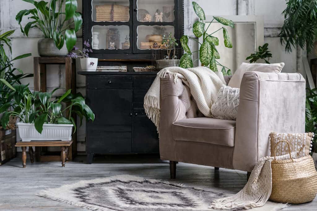 cozy seating area with chair, hutch, and lots of plants