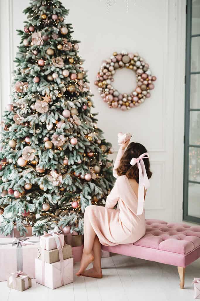 woman taking photo of Christmas tree
