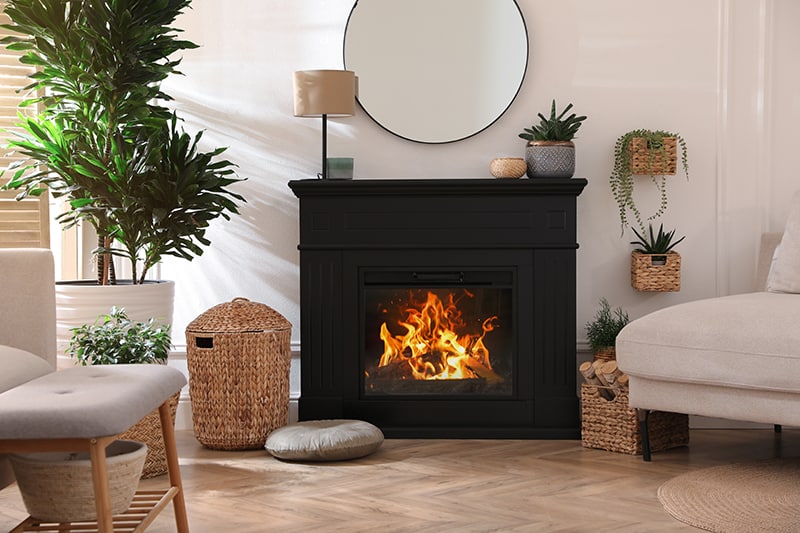 electric fireplace with round mirror over mantel