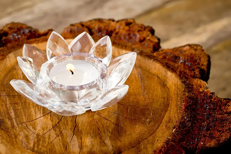 crystal lotus candle holder on top of wood