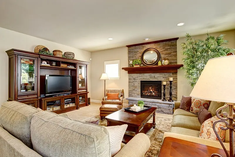 living room with a fireplace and a tv cabinet