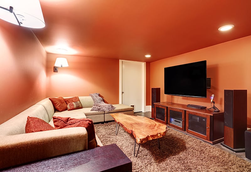 media room with tv, couch, and entertainment center