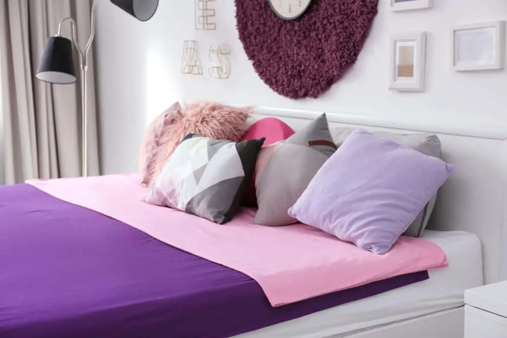 bedroom with purple bedding and decor