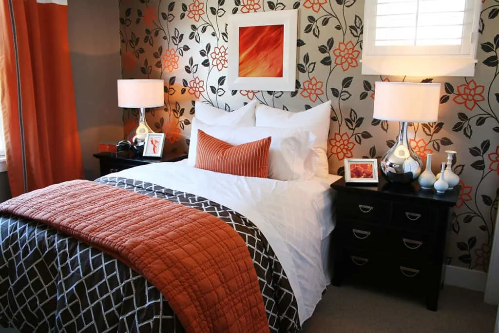 neutral bedroom with pops of orange accents 