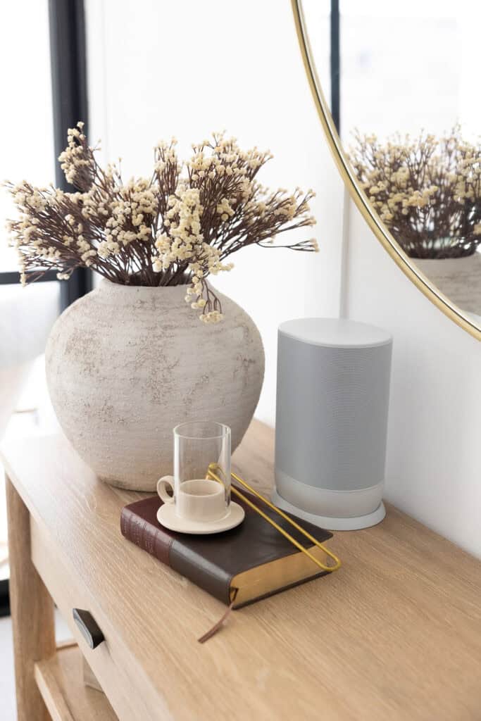 feng shui tips for attracting what you want - entryway table with plants and candles
