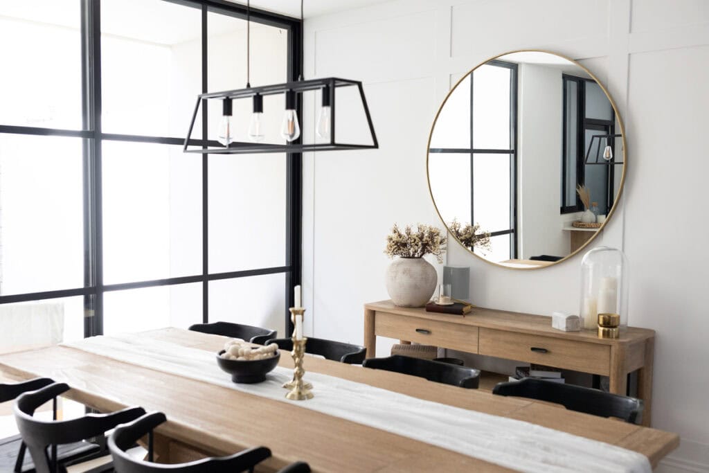 dining room with minimalist decor, table, and mirror