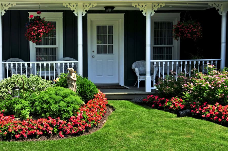 front door of home surrounded by flowers