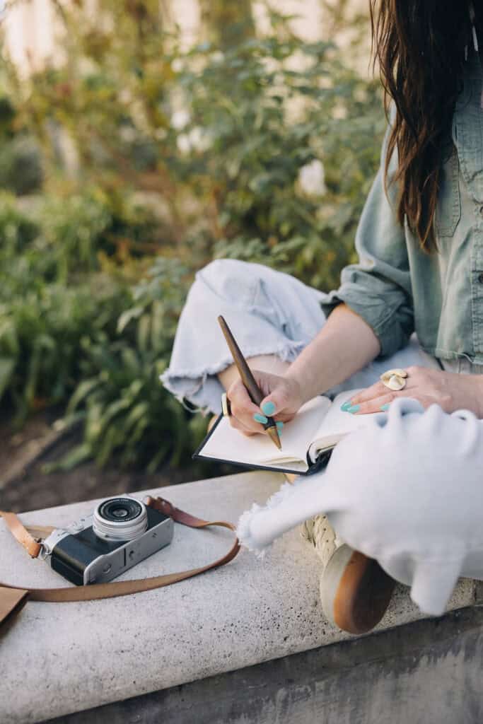 woman writing in a journal - easy feng shui tips to get unstuck
